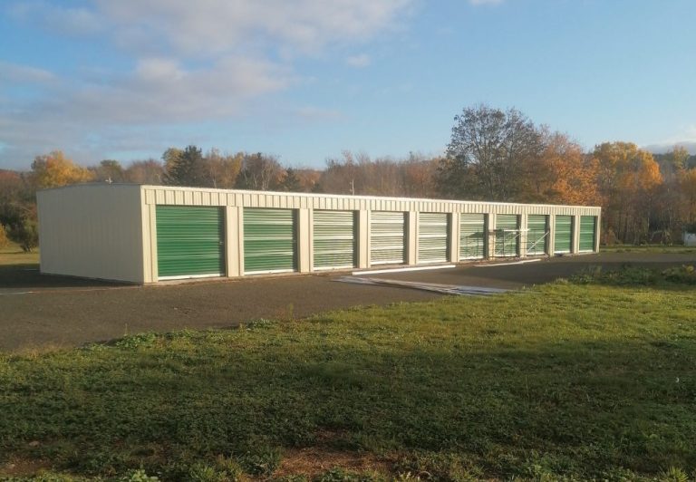 White building with green storage unit doors