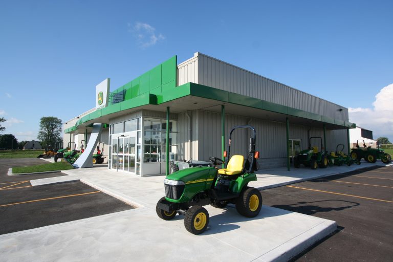 Green tractor outside of green building